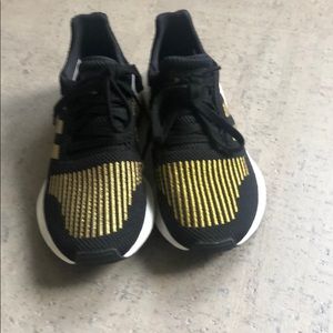 Black and gold adidas sneakers